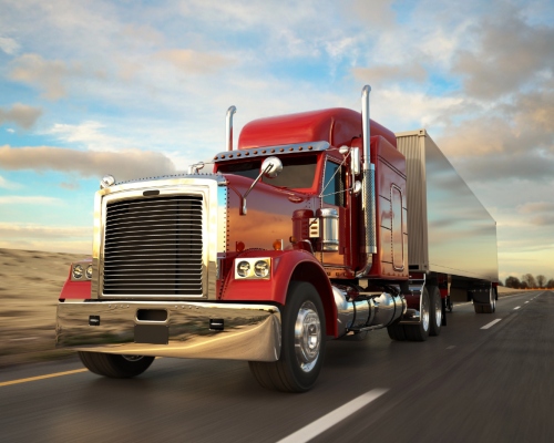 A modern freight truck being loaded with construction materials, representing reliable Freight Transport.